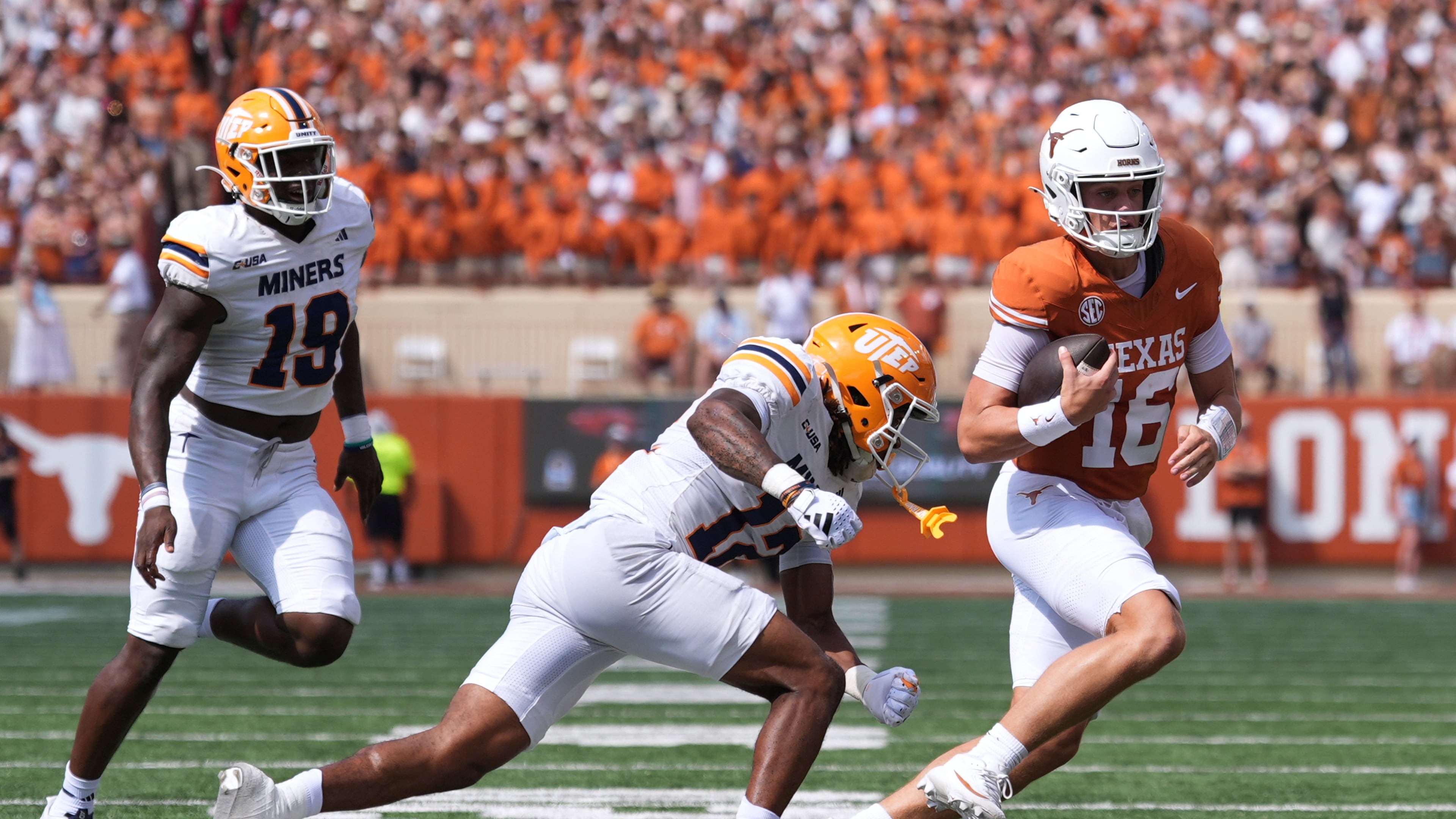 Texas quarterback Arch Manning (16) runs from UTEP linebacker Donte Thompson (12) and defensive lineman Ashaad Hall (19) during the first half of an NCAA college football game in Austin, Texas, Saturday, Sept. 13, 2025. (AP Photo/Eric Gay)