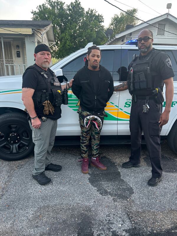 This photo provided by the Orleans Parish Sheriff's Office shows escaped inmate Robert Moody, center flanked by Detective Charles Morgan, left, and Detective Bryant Parish, right, after he had been captured in New Orleans on Friday May, 16, 2025. ( Orleans Parish Sheriff's Office via AP)