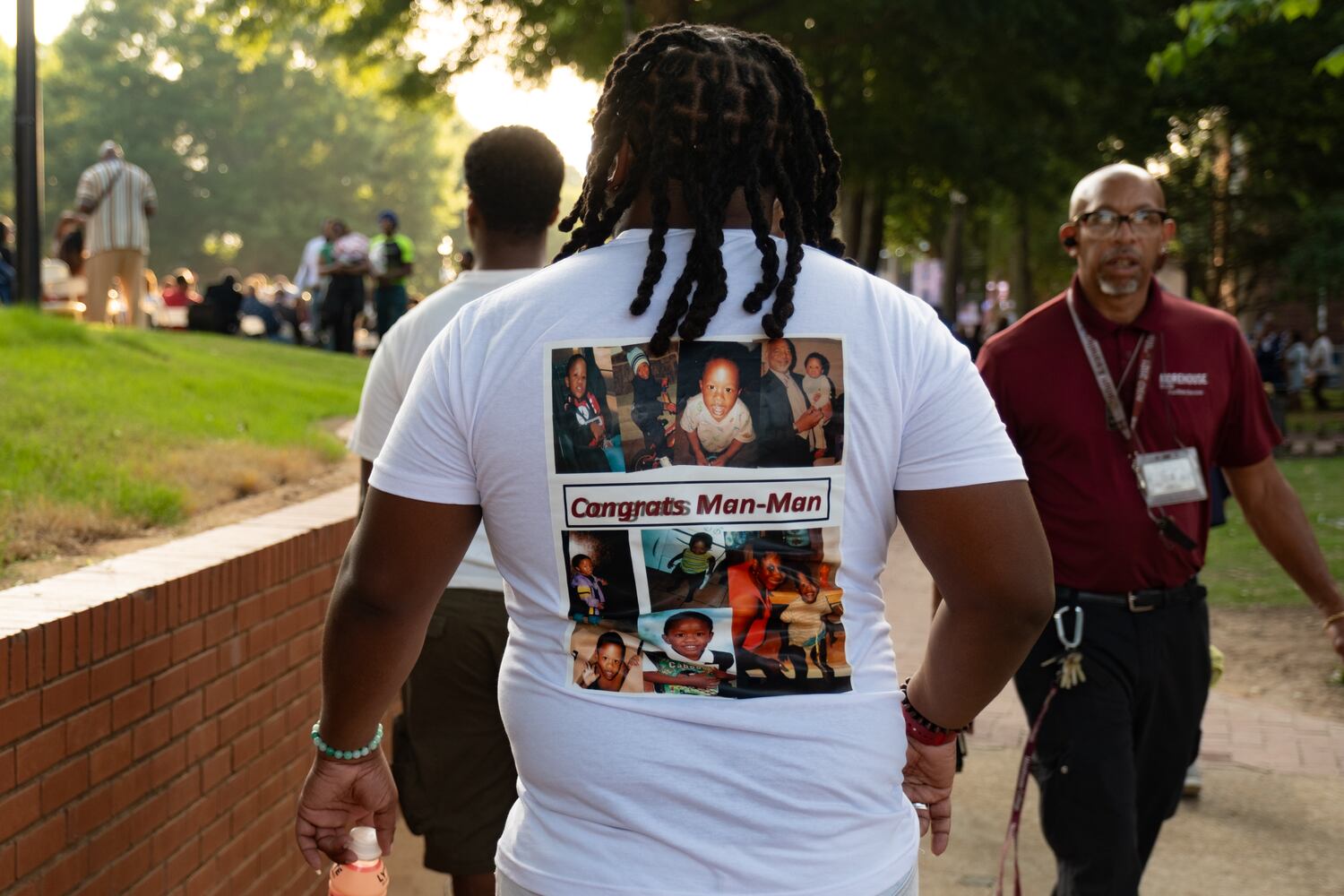 Nolane Purifoy wears a shirt with his brother-in-law’s childhood photos before the start of the Morehouse College graduation Sunday, May 17, 2026. (Ben Gray for the AJC)