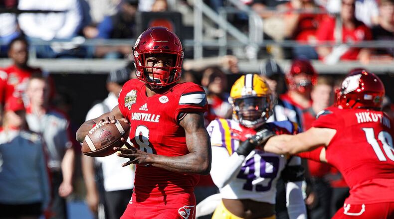 ORLANDO, FL - DECEMBER 31: Lamar Jackson #8 of the Louisville Cardinals looks to pass against the LSU Tigers in the first quarter of the Buffalo Wild Wings Citrus Bowl at Camping World Stadium on December 31, 2016 in Orlando, Florida. (Photo by Joe Robbins/Getty Images)