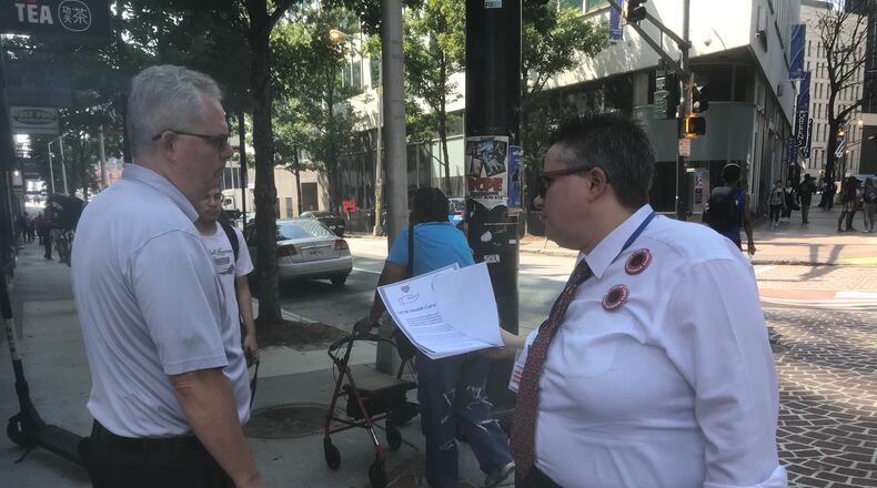Georgia State University employee Deb Loden talks to another employee about a proposal by United Campus Workers of Georgia to demand the University System of Georgia stop its plan to increase employee health care costs next year. Loden, who's worked nearly 12 years at the university, said the cost increases are more than her raises. "It's going to get to a point where I can't work here anymore," Loden said. ERIC STIRGUS/ESTIRGUS@AJC.COM.