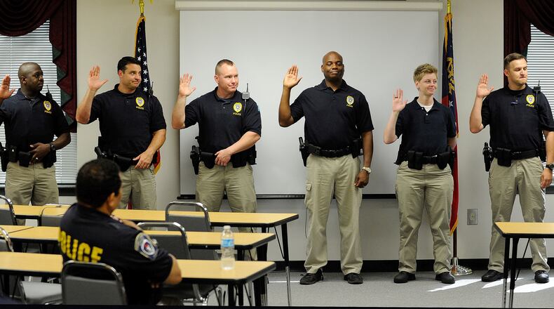 Gwinnett County school resource officers are sworn in for the 2014-15 school year. David Tulis / AJC Special