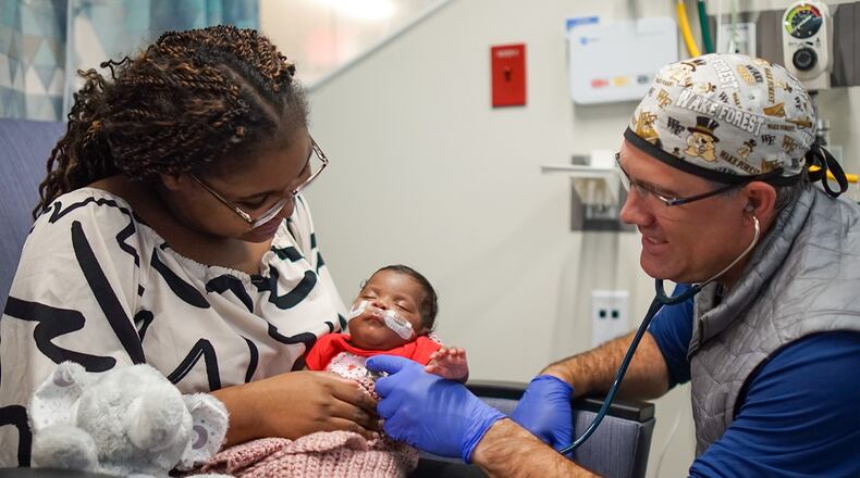 Dr. Brad Buckler examines Tianna Nunnally’s baby, Sky, at the Memorial Health University Medical Center’s Dwaine and Cynthia Willett Children’s Hospital neonatal intensive care unit in Savannah. (Courtesy of Tre Windom)