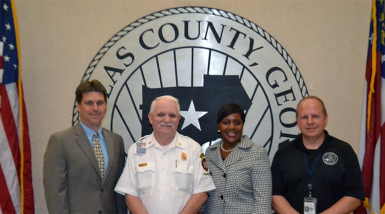 Beginning Sept. 1, the Fire Protection Rating for Douglas County will drop from 4/4X to 3/3X which may result in lower Fire Insurance Premiums, depending on their insurance provider. (L-R) are Gil Shearouse, executive director, Douglasville-Douglas County Water and Sewer Authority; Douglas County Fire Chief Scott Spencer; Dr. Romona Jackson Jones, chairman of the Douglas County Board of Commissioners and Greg Whitaker, director of the Douglas County E-911 Operations Center. Courtesy of Douglas County