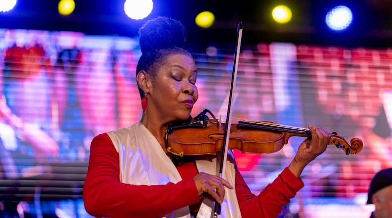 Violinist Karen Briggs performs Saturday at The Stockbridge Amphitheater. Briggs' Contempo Orchestra was the main attraction at a star-filled show that featured Oleta Adams, Phil Perry and Regina Belle. (Ben Hendren for the Atlanta Journal-Constitution)