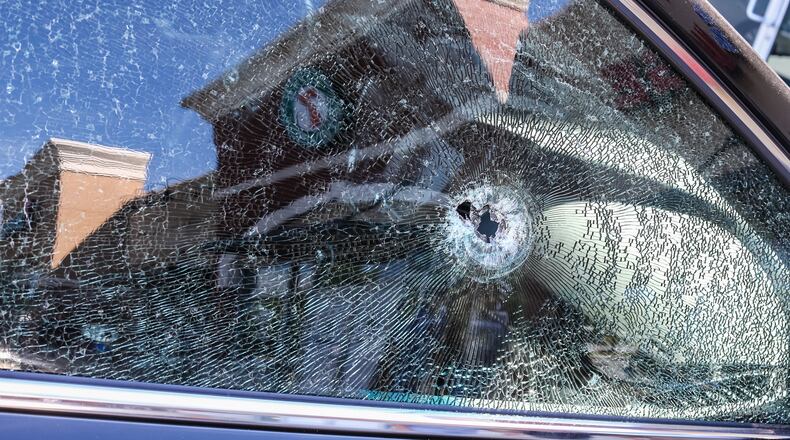A bullet pierced a car window after an attempted robbery turned deadly Mon., June 20, 2016, at a Gwinnett County shopping plaza. JOHN SPINK / JSPINK@AJC.COM