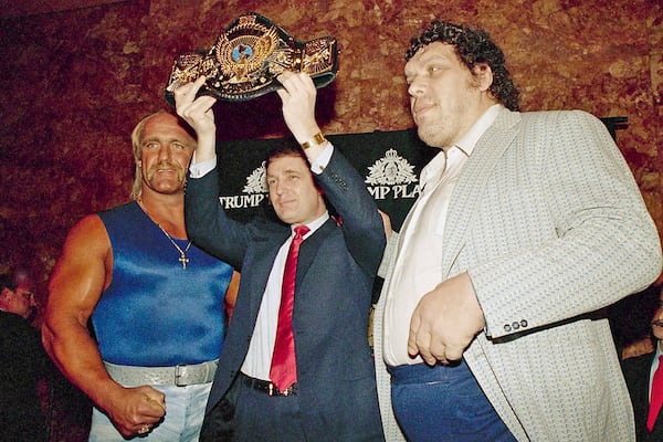 Then-real estate developer Donald Trump held up the World Wrestling Federation Championship belt, flanked by wrestlers Hulk Hogan (left) and Andre the Giant (right) durinig a news conference March 15, 1988, in New York, announcing "WrestleMania IV" at Trump Plaza in Atlantic City. (Susan Ragan/AP)