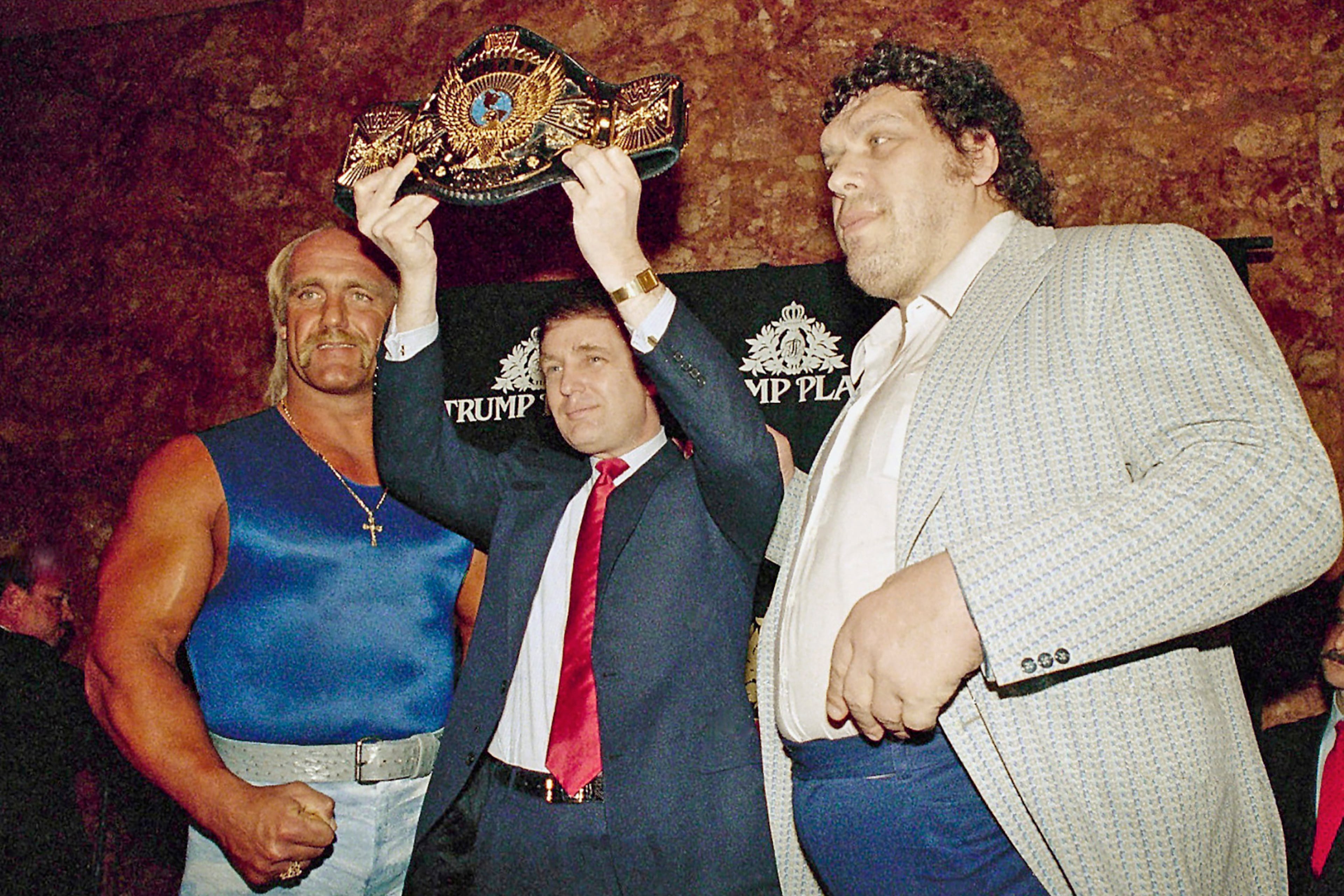Then-real estate developer Donald Trump held up the World Wrestling Federation Championship belt, flanked by wrestlers Hulk Hogan (left) and Andre the Giant (right) durinig a news conference March 15, 1988, in New York, announcing "WrestleMania IV" at Trump Plaza in Atlantic City. (Susan Ragan/AP)