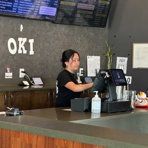 Karen Ajanel serves a customer at her job. Ajanel, a Dalton State College student, credits the Orange Duffel Bag Initiative, credits the program with helping in her academic journey. (Courtesy)