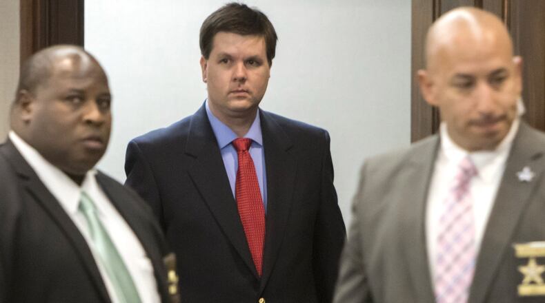 Ross Harris (center) walks into court flanked by sheriff’s deputies. (Stephen B. Morton for The Atlanta Journal Constitution)