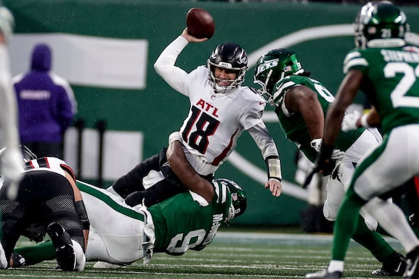 Jets defensive end Will McDonald IV (bottom) sacks Falcons quarterback Kirk Cousins on Sunday.