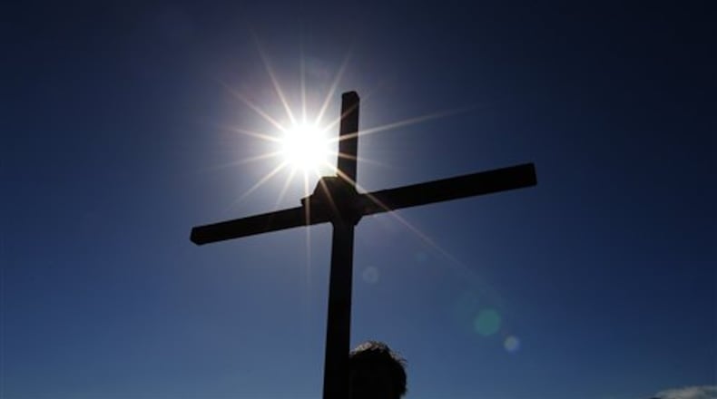 Pilgrims walk with crosses as the Northern Cross pilgrimage makes its final leg of the journey to Holy Island, Berwick Upon Tweed, England, Friday, April 18, 2014. For more than 30 years, groups of pilgrims celebrate Easter by crossing the tidal causeway during the annual Christian cross carrying pilgrimage to Holy Island , the pilgrims walk around 100 miles through Northumberland and the Scottish Borders during Holy Week. (AP Photo/Scott Heppell)