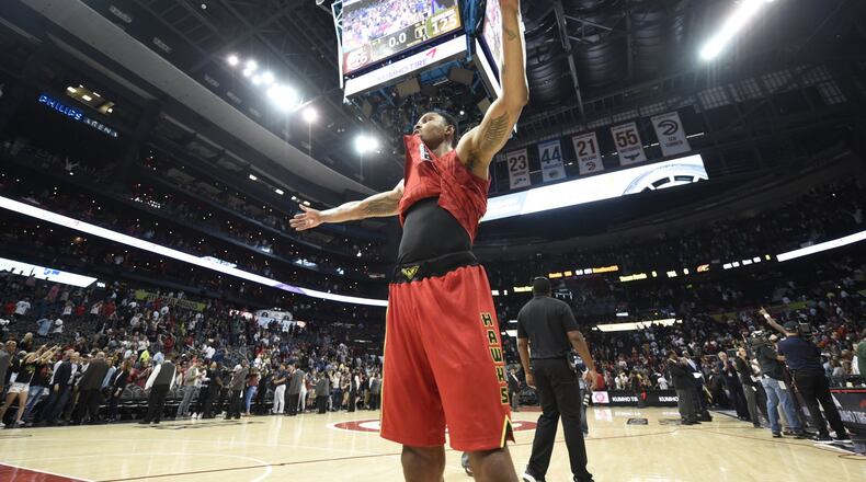 The Hawks’ Kent Bazemore raises his arms in victory after his team defeated the Cleveland Cavaliers at Phillips Arena on April 9, 2017. The Hawks won in overtime 126-125 after coming back from 26 points down in the fourth quarter. (Henry Taylor/henry.taylor@ajc.com)