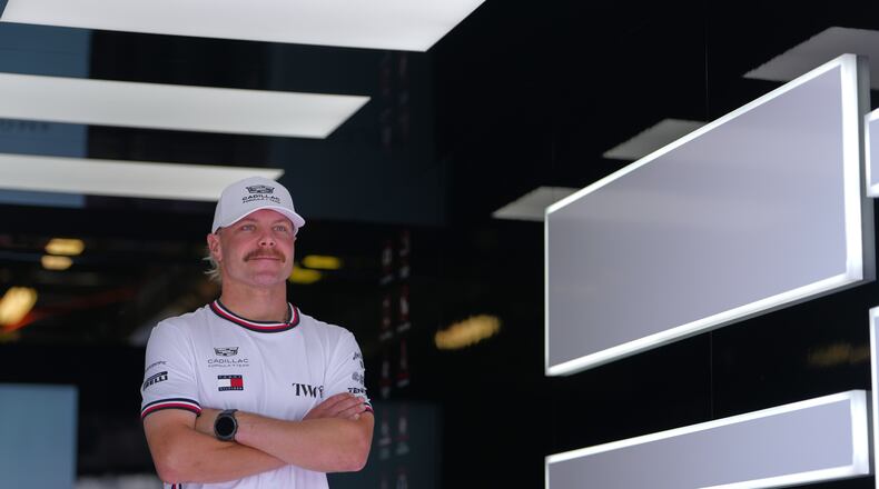 FILE - Cadillac driver Valtteri Bottas, of Finland, poses in his team garage ahead of the Australian Formula One Grand Prix at Albert Park, in Melbourne, Australia, Thursday, March 5, 2026. (AP Photo/Asanka Brendon Ratnayake, File)