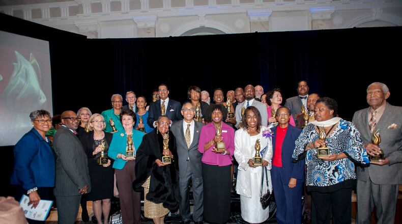DeKalb County CEO Burrell Ellis named 25 "community heroes" Tuesday night at the annual CEO's award ceremony. Here, Ellis, center in grey, poses with winners.(Credit: DeKalb County)