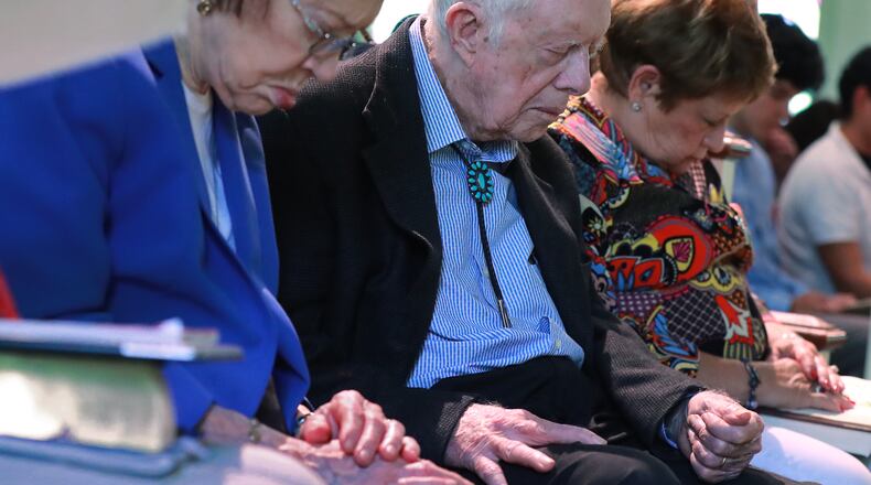 President Jimmy Carter and Rosalynn bow in prayer along with members and visitors during the worship service at Maranatha Baptist Church in Plains, Georgia on Sunday, June 9, 2019, less than a month after the 39th U.S. president and Plains native fell, breaking his hip.  Curtis Compton/ccompton@ajc.com