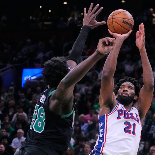 Philadelphia 76ers center Joel Embiid (21) takes a shot over Boston Celtics center Neemias Queta (88) during the second half of Game 5 of a first-round NBA playoffs basketball series, Tuesday, April 28, 2026, in Boston. (AP Photo/Charles Krupa)