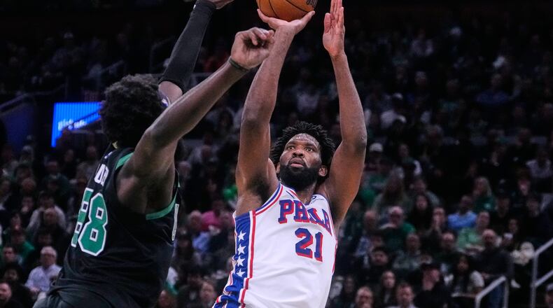 Philadelphia 76ers center Joel Embiid (21) takes a shot over Boston Celtics center Neemias Queta (88) during the second half of Game 5 of a first-round NBA playoffs basketball series, Tuesday, April 28, 2026, in Boston. (AP Photo/Charles Krupa)
