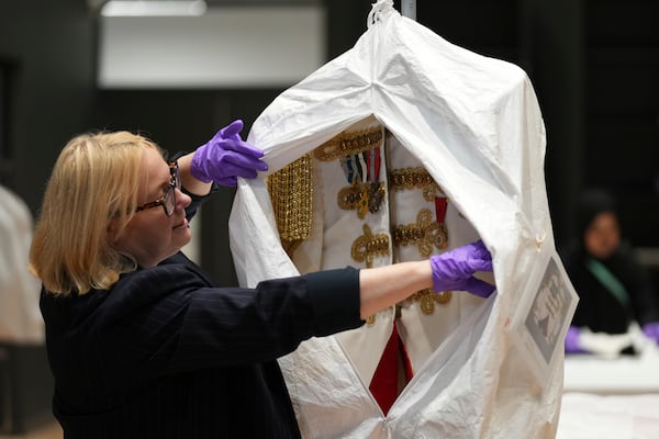 Kate Parsons, Director of Collections Care and Access, shows a costume worn by Elton John on his 1981 world tour, at the V&A Storehouse in London, Thursday, June 5, 2025, the jacket was designed by Bob Mackie. (AP Photo/Joanna Chan)