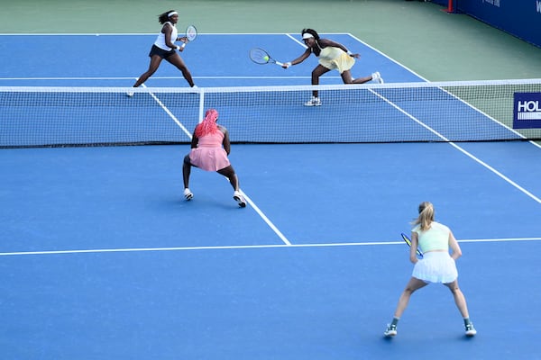 Hailey Baptiste, top left, and Venus Williams top right, compete during a doubles match against Eugenie Bouchard, bottom right, and Clervie Ngounoue, bottom left, at the Citi Open tennis tournament Monday, July 21, 2025, in Washington. (AP Photo/Nick Wass)