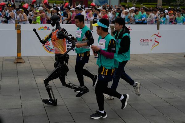 A robot takes part in what is billed as the world's first robot half marathon during the Humanoid Robot Half-Marathon held in Beijing on Saturday, April 19, 2025. (AP Photo/Ng Han Guan)