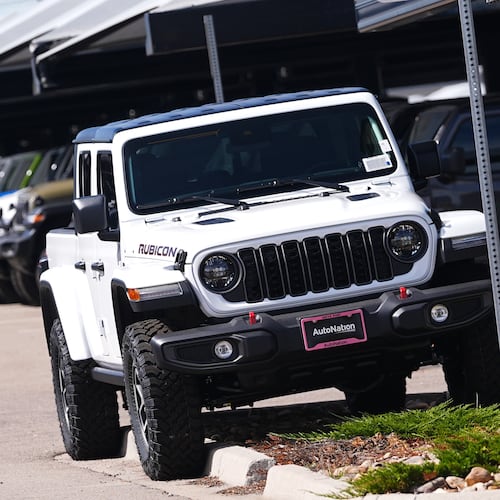 Unsold 2025 Gladiator pickup trucks sit on display outside a Jeep dealership Friday, Sept. 26, 2025, in Englewood, Colo. (David Zalubowski/AP)