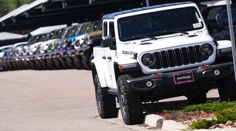 Unsold 2025 Gladiator pickup trucks sit on display outside a Jeep dealership Friday, Sept. 26, 2025, in Englewood, Colo. (David Zalubowski/AP)