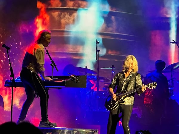 Tommy Shaw and Lawrence Gowan of Styx jam during 'Blue Collar Man" at Ameris Bank Amphitheatre in Alpharetta July 6, 2025. RODNEY HO/ajc