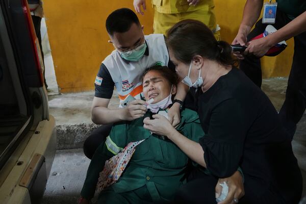 Natthanan Kaewkaiyasit, whose husband died in an under-construction high-rise building that collapsed on Friday, cries as she waits to take his body from a mortuary of a police hospital, in Bangkok, Thailand, Monday, March 31, 2025. (AP Photo/Sakchai Lalit)
