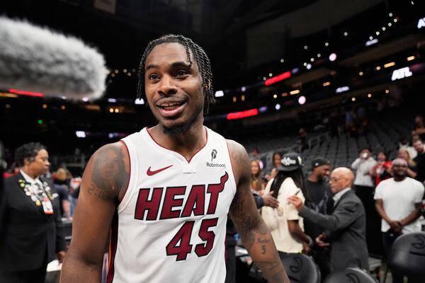 Miami Heat guard Davion Mitchell (45) leaves the court after a win against the Atlanta Hawks, after an NBA play-in tournament basketball, Friday, April 18, 2025, in Atlanta. (AP Photo/Brynn Anderson)