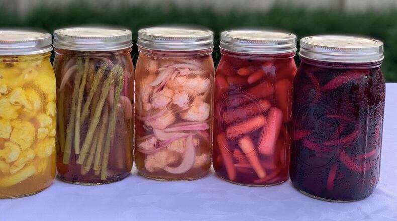There’s more than one combination for pickling vegetables. Here are some options: (from left) cauliflower with saffron and coriander seeds; asparagus with red onion and brown mustard seeds; cauliflower with red onion and black peppercorns; tricolored baby carrots with fresh dill; and beets with white onion and ginger. CONTRIBUTED BY KELLIE HYNES