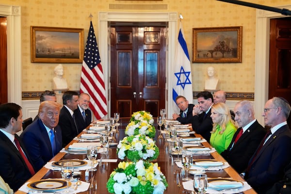 President Donald Trump, second from left, meets with Israel's Prime Minister Benjamin Netanyahu, second from right, as Secretary of State Marco Rubio, from left, Defense Secretary Pete Hegseth, obstructed, CIA Director John Ratcliffe, U.S. Ambassador to Israel Mike Huckabee, and from right, Israeli Ambassador to the U.S. Yechiel Leiter, Netanyahu's wife Sara Netanyahu, Israel's Strategic Affairs Minister Ron Dermer, Israel's National Security Council head Tzachi Hanegbi and Israel's Cabinet Secretary Yossi Fuchs listen in the Blue Room of the White House, Monday, July 7, 2025, in Washington. (AP Photo/Alex Brandon)