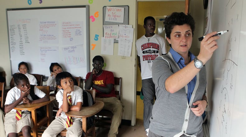Students pay close attention as Luma Mufleh talks during a team meeting in Clarkston in the fall of 2012. When Mufleh first moved to Atlanta, she says she was “lost,” unsure what to do with her life. She was smart, recently graduated from Smith College. She was waiting tables, working in IT when she took a wrong turn and her life changed. Mufleh was recently named one of the top 10 CNN Heroes of 2016. AJC FILE PHOTO