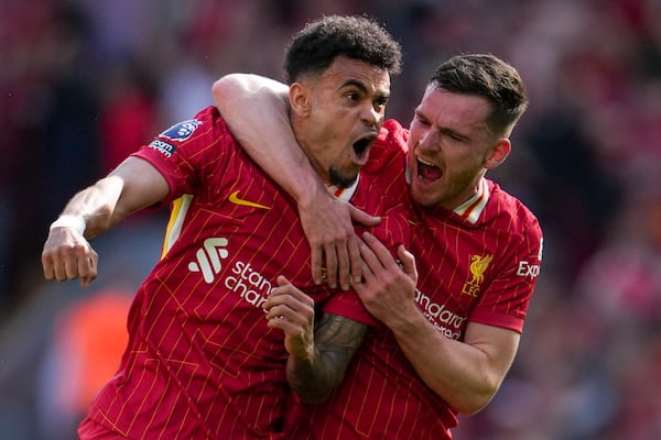 Liverpool's Luis Diaz, left, celebrates with Liverpool's Andrew Robertson after scoring his side's first goal during the English Premier League soccer match between Liverpool and Tottenham Hotspur at Anfield in Liverpool, England, Sunday, April 27, 2025. (AP Photo/Jon Super)