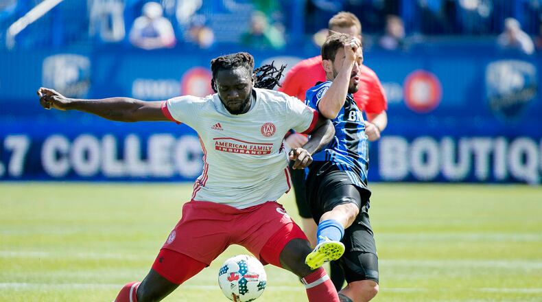 Montreal Impact's Hernan Bernardello, right, challenges Atlanta United's Kenwyne Jones during the first half of an MLS soccer game in Montreal, Saturday, April 15, 2017. (Graham Hughes/The Canadian Press via AP)