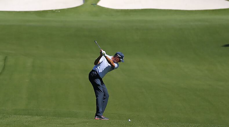 Matt Kuchar hits his fairway shot to the 7th green during the first practice round at Augusta National Golf Club on Monday in Augusta. Curtis Compton / ccompton@ajc.com
