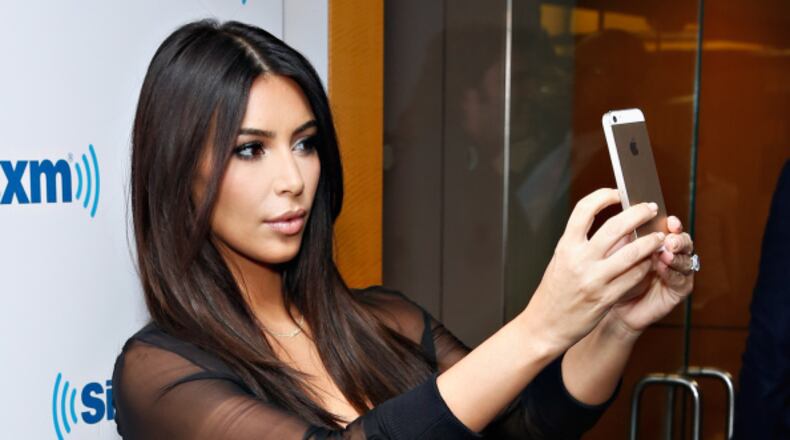 NEW YORK, NY - AUGUST 11: (EXCLUSIVE COVERAGE/SPECIAL RATES APPLY) TV personality Kim Kardashian takes a selfie at the SiriusXM Studios on August 11, 2014 in New York City. (Photo by Cindy Ord/Getty Images)