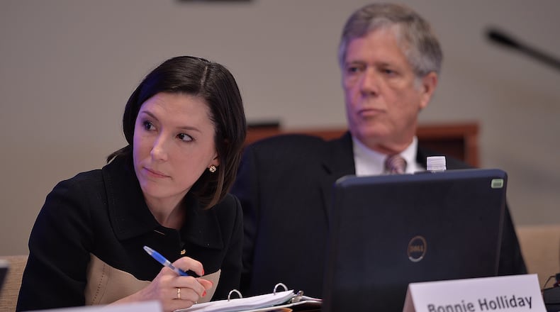 Bonnie Holliday, Executive Director of the State Charter Schools Commission of Georgia, and Tom Lewis listen to Chairman Dr. Charles Knapp during the State Charter Schools Commission meeting on Wednesday, May 29, 2013.