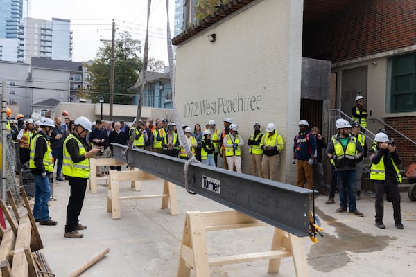People gather for the topping out ceremony for the 1072 W Peachtree St. building in Atlanta on Friday, November 7, 2025. The mixed-use tower will be Atlanta’s fifth tallest building. (Arvin Temkar/AJC)