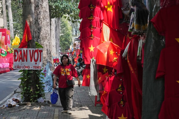 A woman walks after watching a parade celebrating the 50th anniversary of the end of the Vietnam War in Ho Chi Minh City, Vietnam, Wednesday, April 30, 2025. (AP Photo/Achmad Ibrahim)