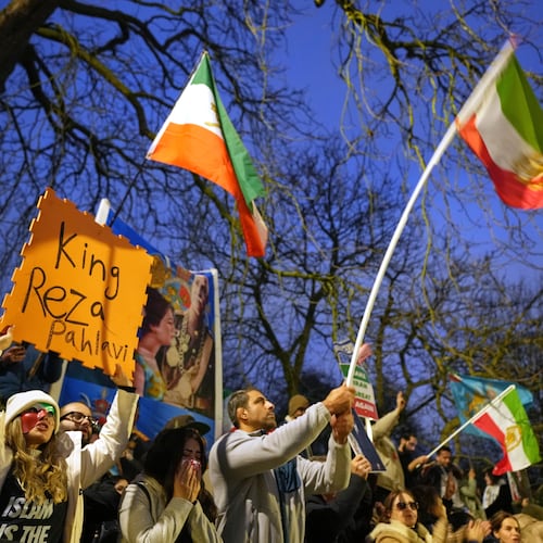 Protesters hold up placards and flags as they demonstrate outside the Iranian Embassy in London, Monday, Jan. 12, 2026. (AP Photo/Alastair Grant)