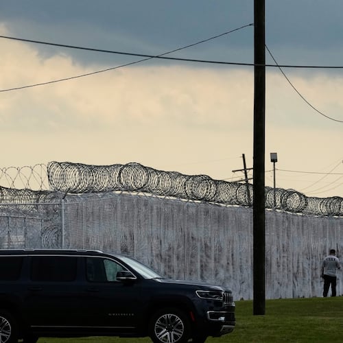 FILE - Security walk outside "Camp 57," a facility to house immigration detainees at the Louisiana State Penitentiary in Angola, La., on Sept. 3, 2025. (AP Photo/Gerald Herbert, File)