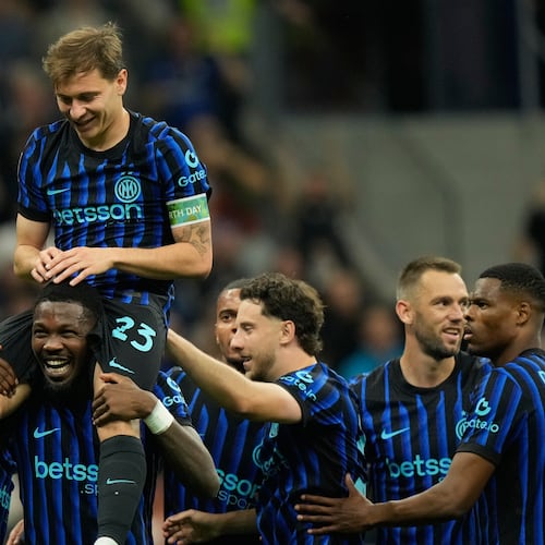 Inter Milan's Nicolo Barella, on Marcus Thuram shoulders, celebrates after scoring his side's 2nd goal during the Serie A soccer match between Inter Milan and Cagliari in Milan, Italy, Friday, April 17, 2026. (AP Photo/Luca Bruno)