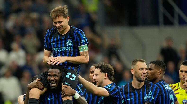 Inter Milan's Nicolo Barella, on Marcus Thuram shoulders, celebrates after scoring his side's 2nd goal during the Serie A soccer match between Inter Milan and Cagliari in Milan, Italy, Friday, April 17, 2026. (AP Photo/Luca Bruno)