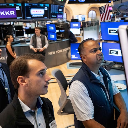Specialists Dilip Patel, right, and Dylan Halvorsen work on the floor of the New York Stock Exchange in New York, Friday, Aug. 21, 2026. (AP Photo/Yuki Iwamura)