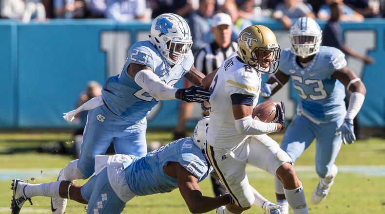 Georgia Tech’s Ricky Jeune (2) carries the ball as North Carolina’s M.J. Stewart (6) and Caryson Collins (23) reach for a tackle during the second half of an NCAA college football game in Chapel Hill, N.C., Saturday, Nov. 5, 2016. North Carolina beat Georgia Tech 48-20. (AP Photo/Ben McKeown)