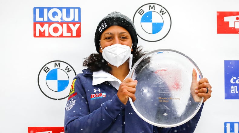 Elana Meyers Taylor from the United States poses at the award ceremony after winning the women's monobob at the Bobsled World Cup race in Igls, near Innsbruck, Austria in Igls, Austria, Saturday, Nov. 27, 2021. (AP Photo/Lisa Leutner)
