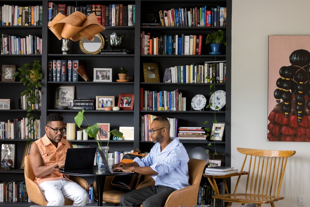 Everett Long and Fred Smith work in the library of their Midtown home. (Tomas Espinoza for the AJC)