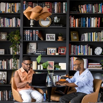 Everett Long and Fred Smith work in the library of their Midtown home. (Tomas Espinoza for the AJC)