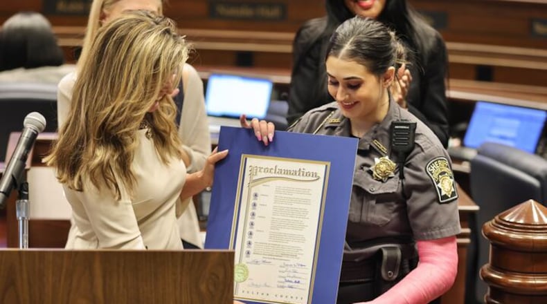 Detention Officer Brooklyn Unitas receives a proclamation from Fulton County Commissioner Bridget Thorne, declaring May 3 as Detention Officer Brooklyn Unitas Appreciation Day. Unitas was injured April 7 when attacked by an inmate in the jail's mental health unit.